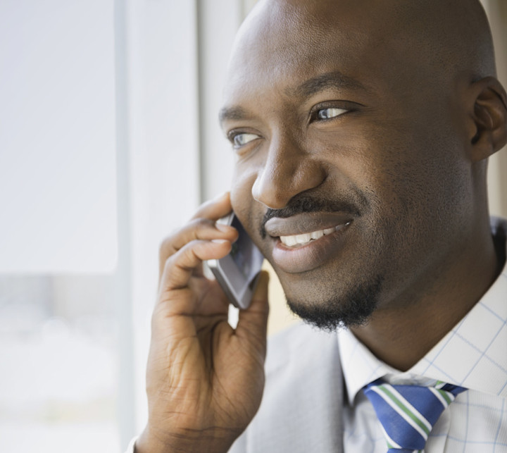 Smiling businessman using smart phone ZA