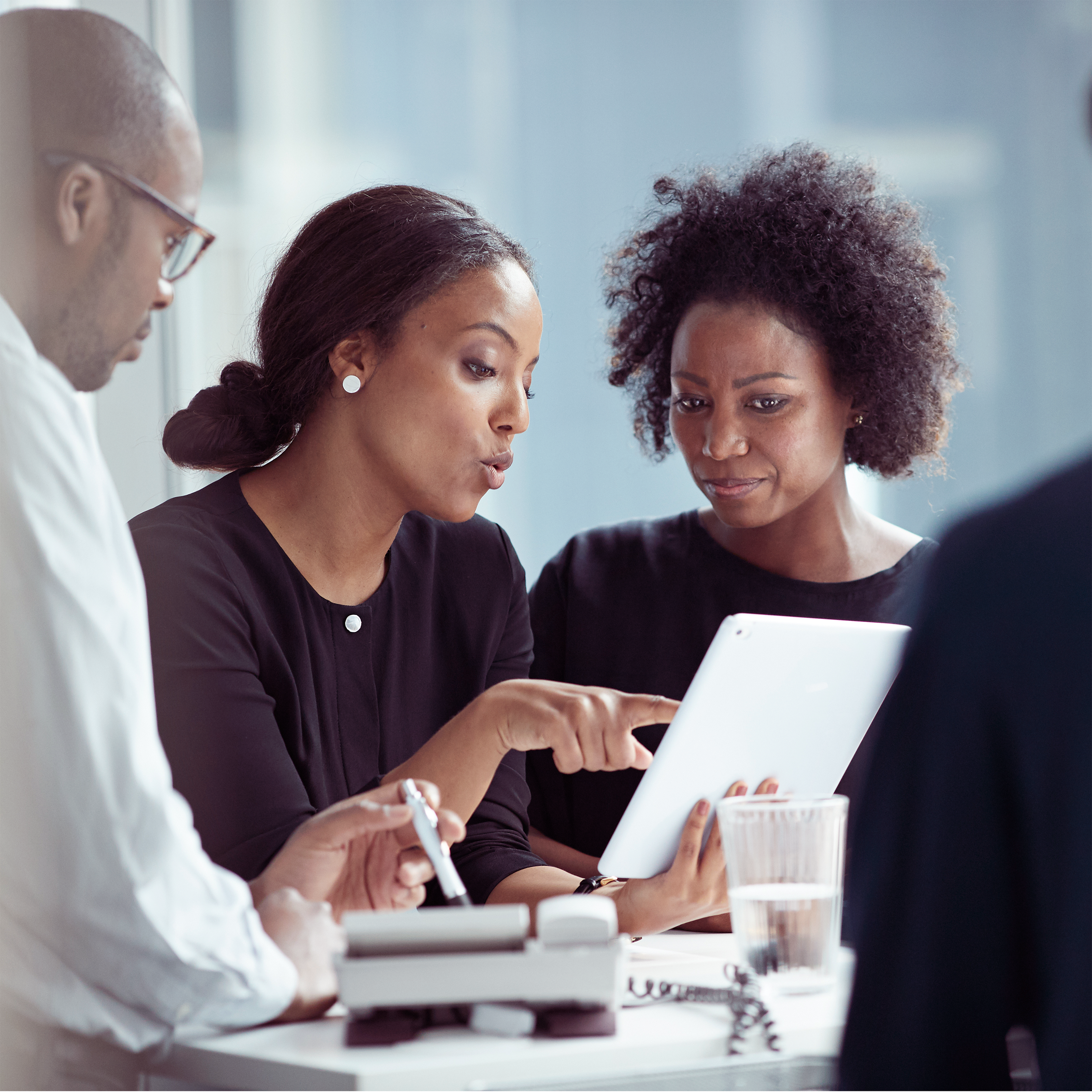 Two business women looking at a tablet in collaboration 