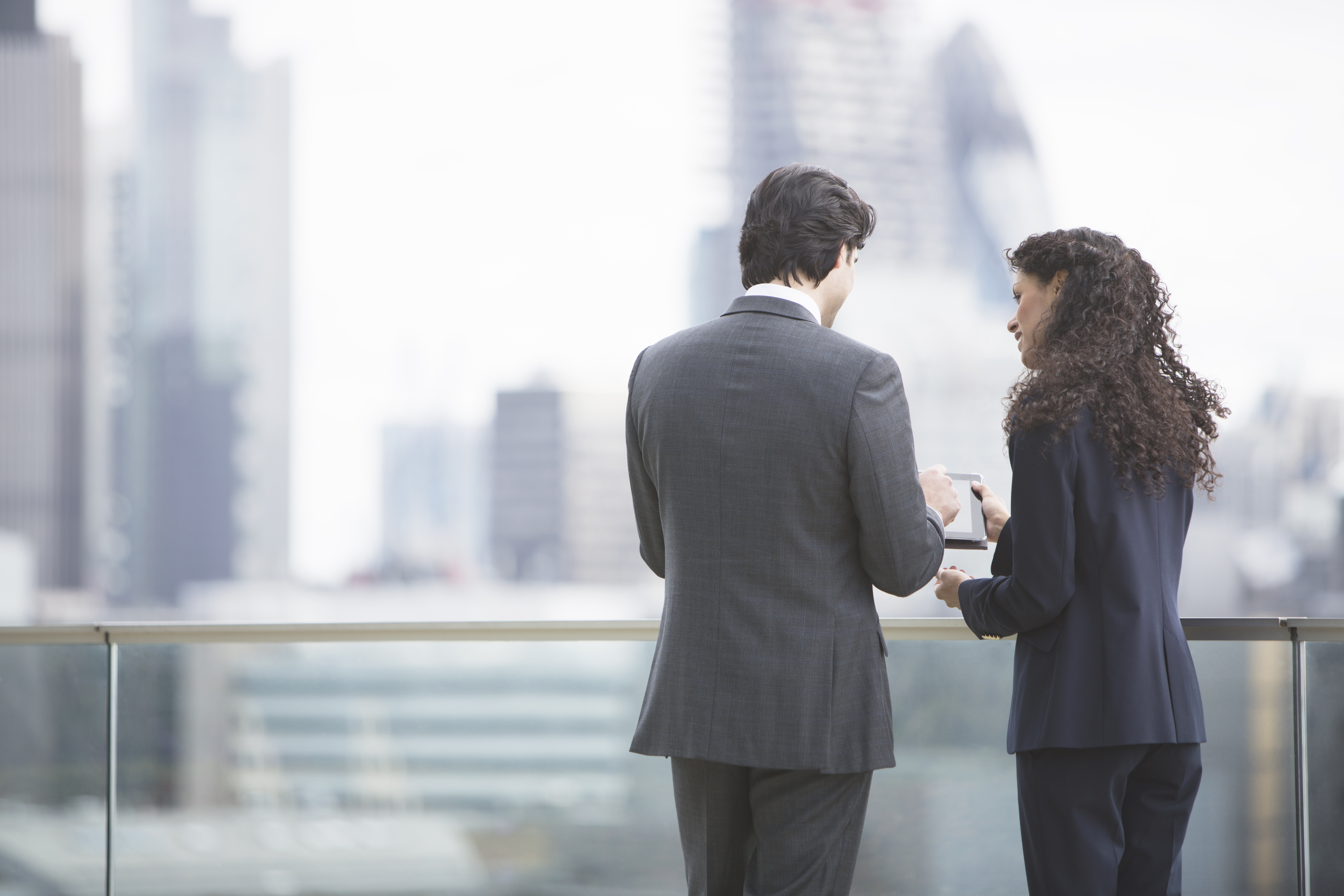 Business people using digital tablet outdoors