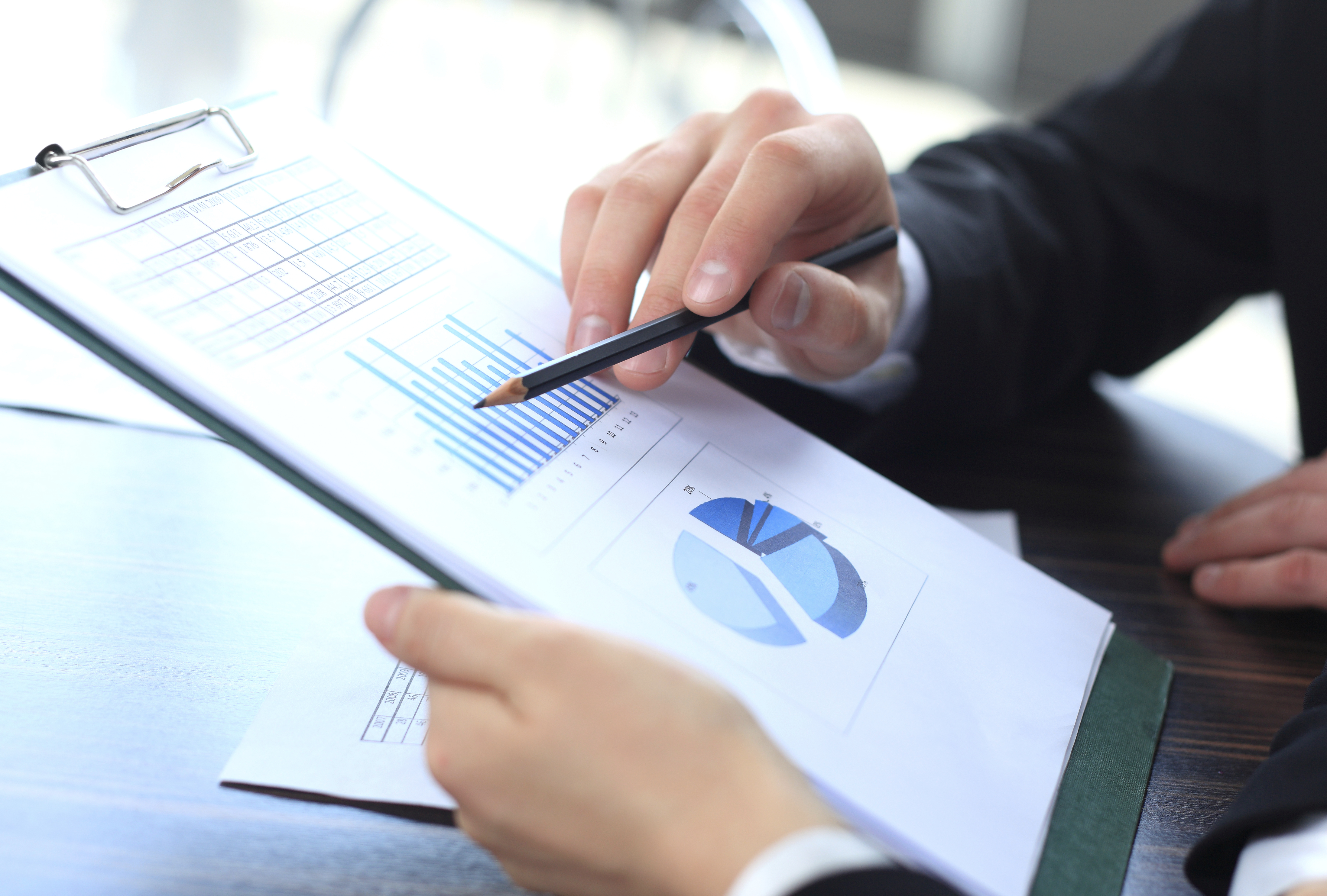 Image of male hand pointing at business document during discussion