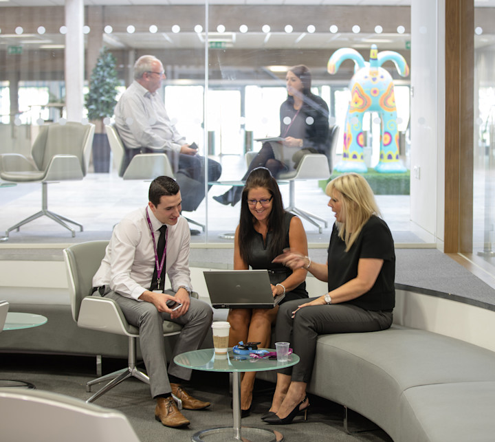 three bristol employees looking at a laptop