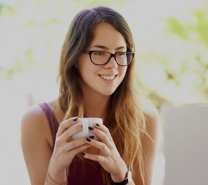 smiling woman looking at laptop