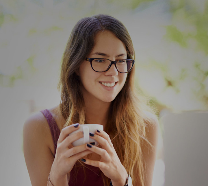 smiling woman looking at laptop