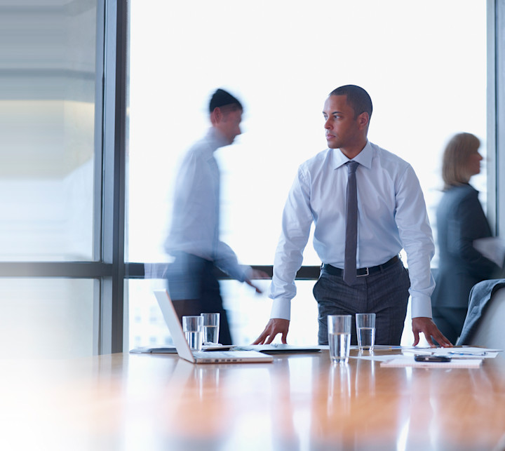 istock-79365707-manstandingbyboardtable