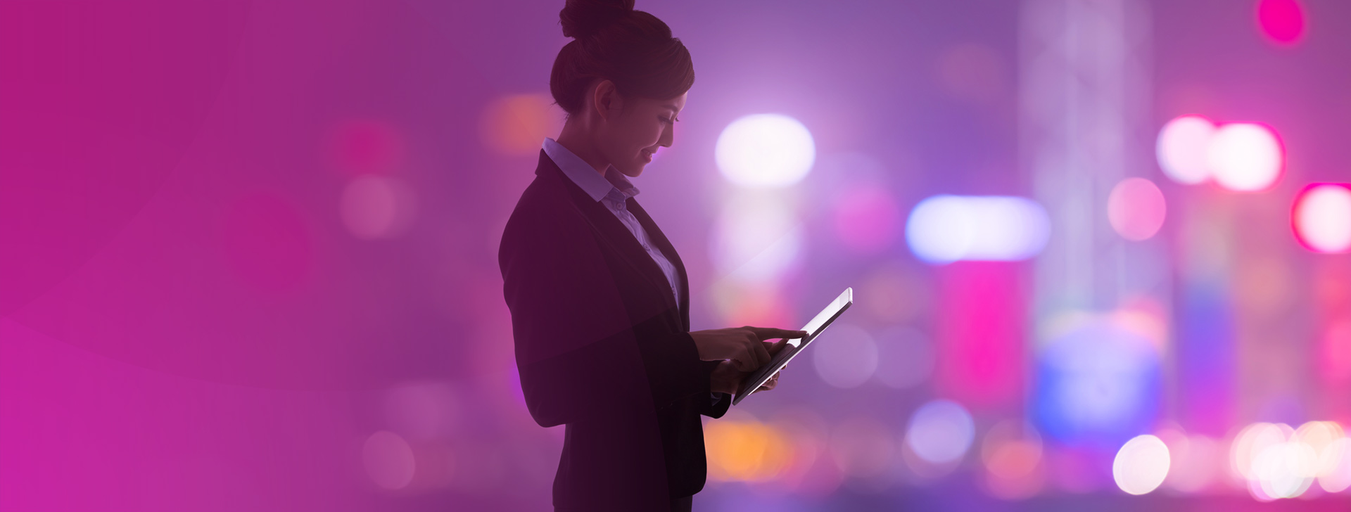 A businesswoman engages with a tablet device.