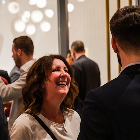 An attendee enjoying the networking at the celebration of Australia Day Tile image of An attendee enjoying the networking at the celebration of Australia Day