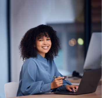 Women sat at table on a laptop
