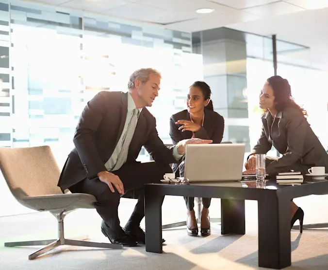 Business people with laptop meeting in lobby