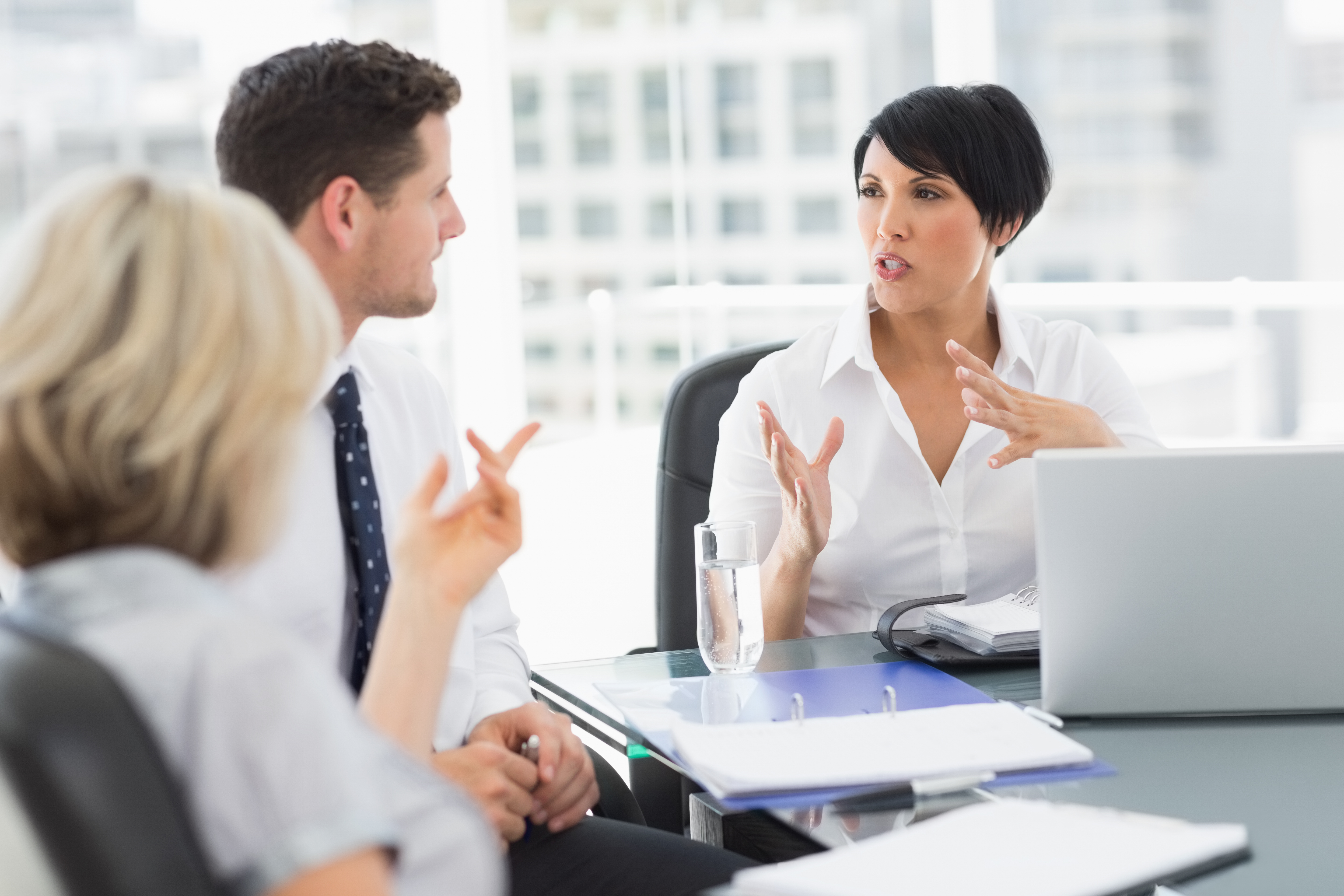Well dressed business people in discussion at office
