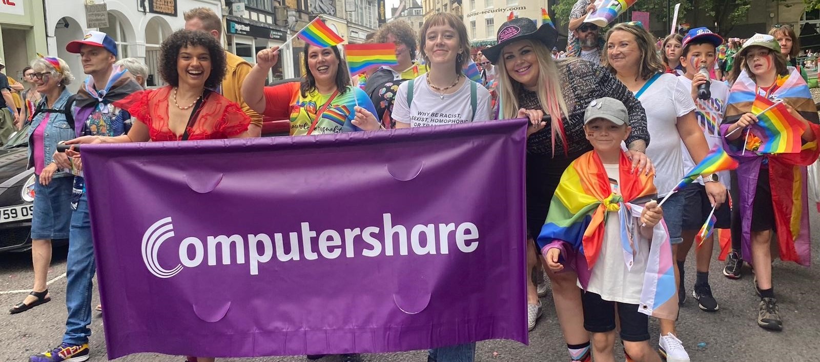 A group of people walking with a Computershare banner at Bristol Pride