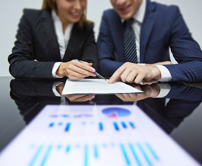 two business people looking at a report