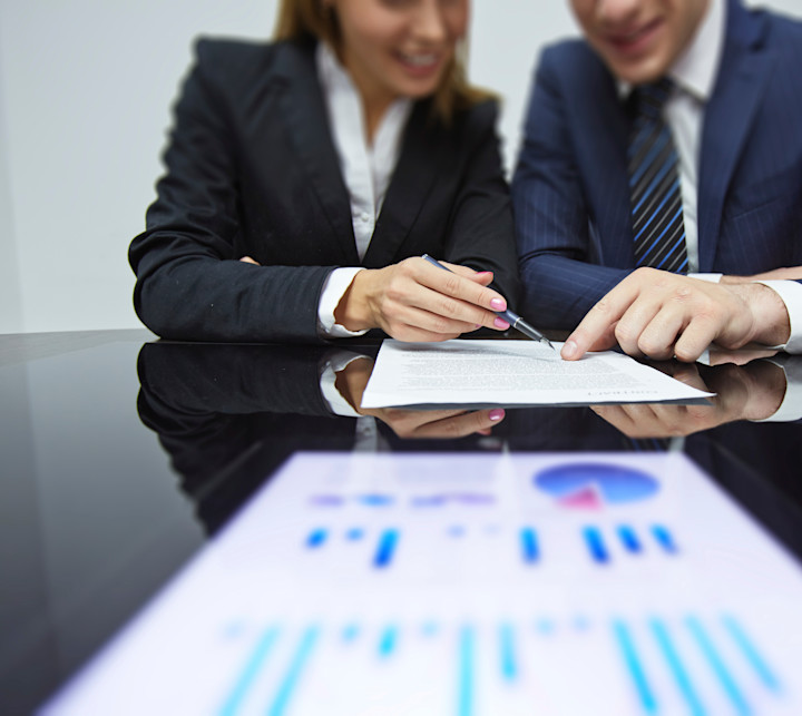 two business people looking at a report