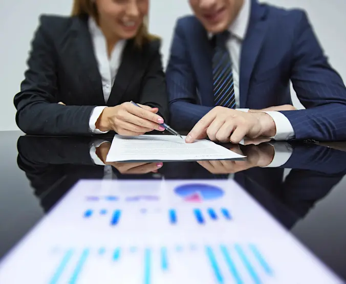 Two people looking at a report