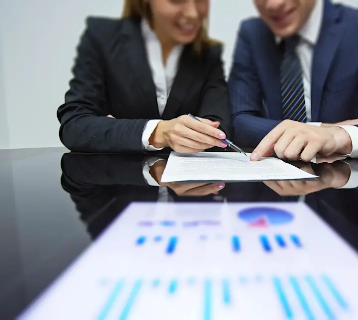 Two people looking at a report