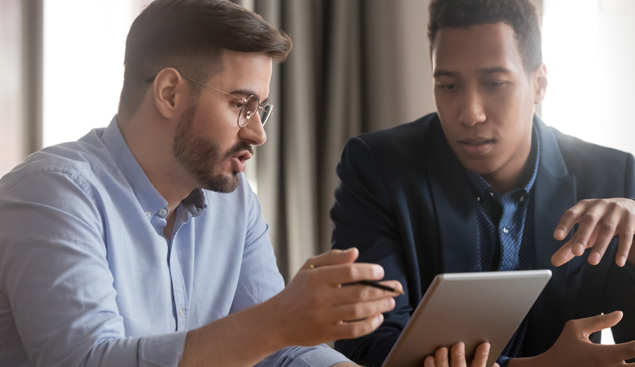 iStock-1254063693-discussing-technology-900x520