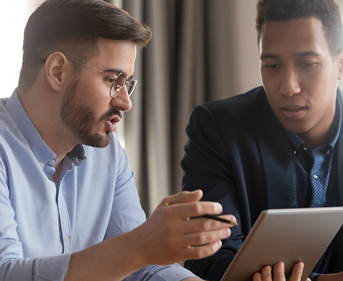 iStock-1254063693-discussing-technology-900x520