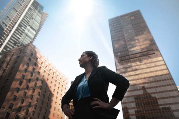 Low angle view of Caucasian businesswoman looking away at downtown cityscape