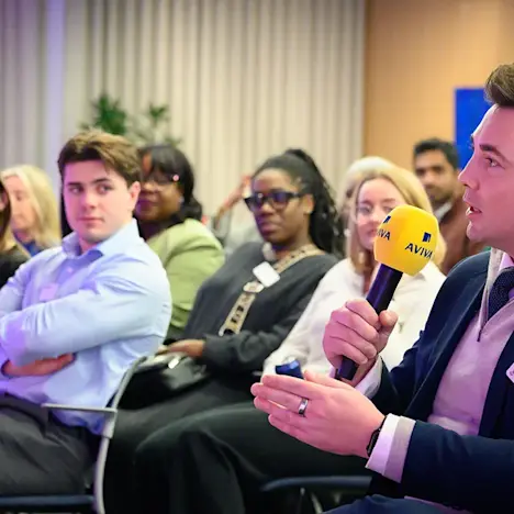 A speaker asks a question to our OpenSpace panelists Tile image of A speaker asks a question to our OpenSpace panelists