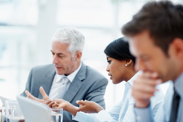 Corporate employees deep in discussion in a meeting