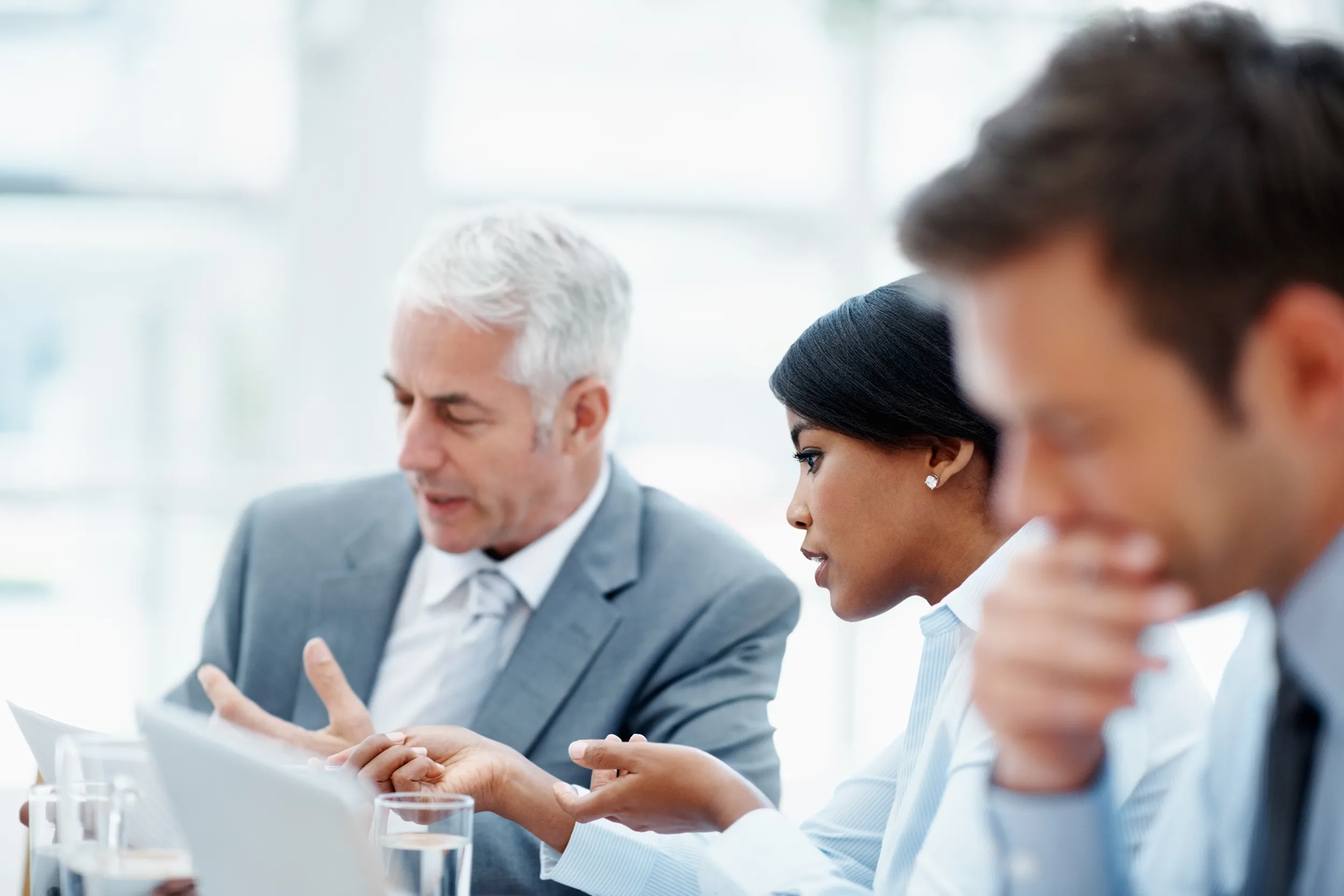 Corporate employees deep in discussion in a meeting