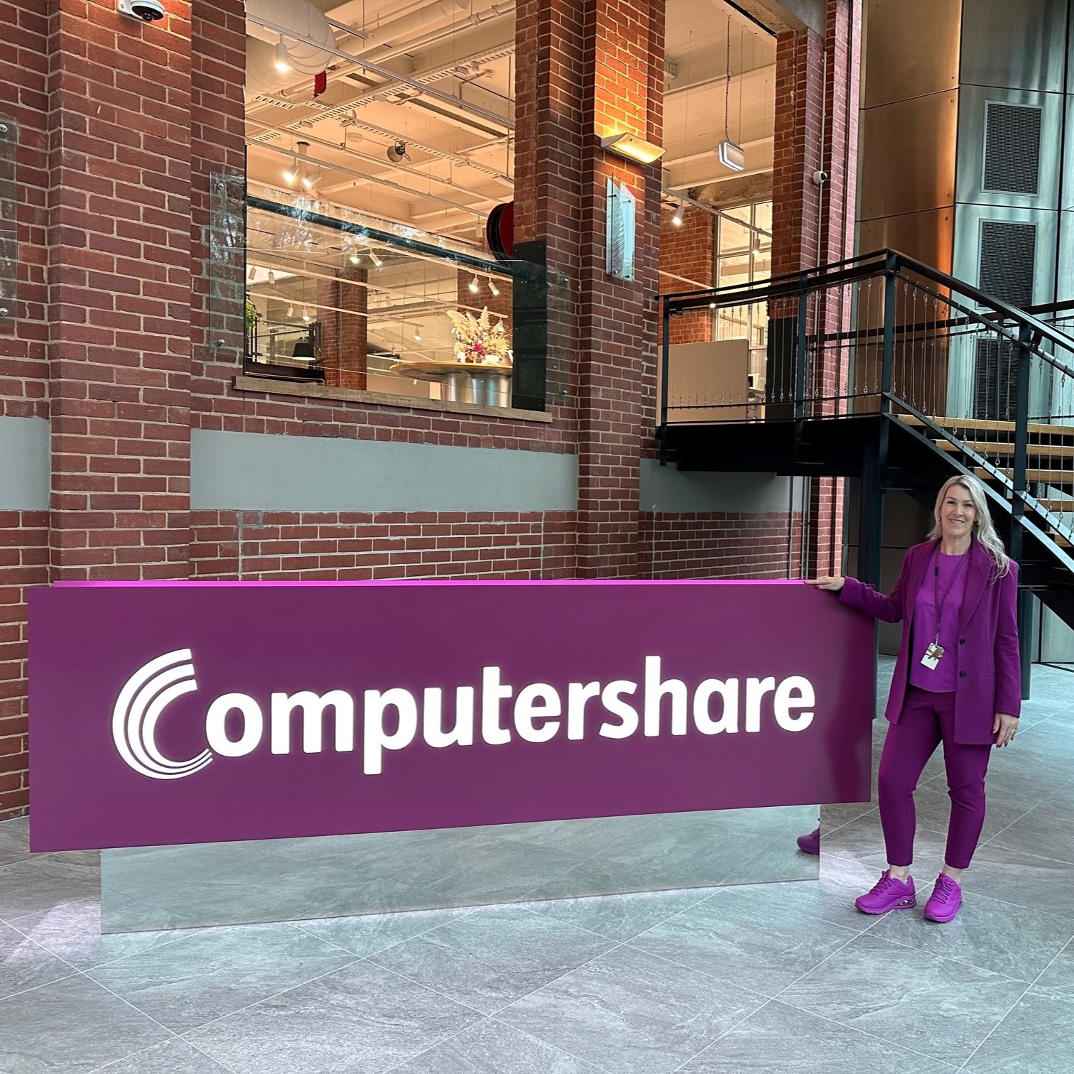 Tania stood by a Computershare sign