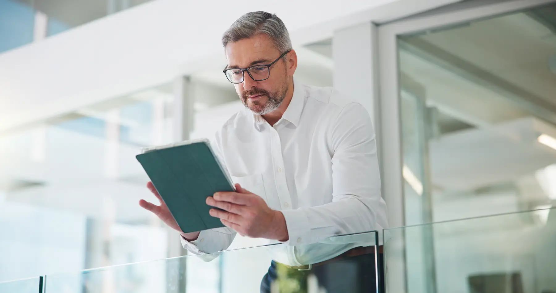 GettyImages-2251544663-man-with-beard-looking-at-ipad