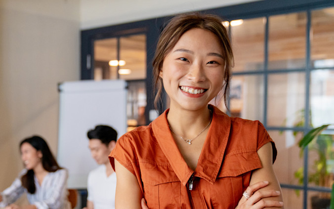 iStock-1141734069-Happy-Employee-Orange-Shirt-1280x750