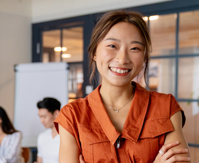 iStock-1141734069-Happy-Employee-Orange-Shirt-1280x750