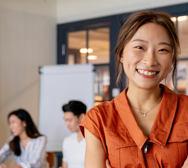 iStock-1141734069-Happy-Employee-Orange-Shirt-1280x750