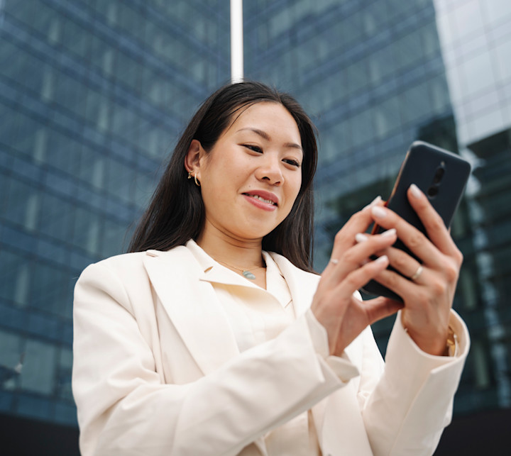 iStock-1432466417-Woman-Looking-at-Mobile-Phone