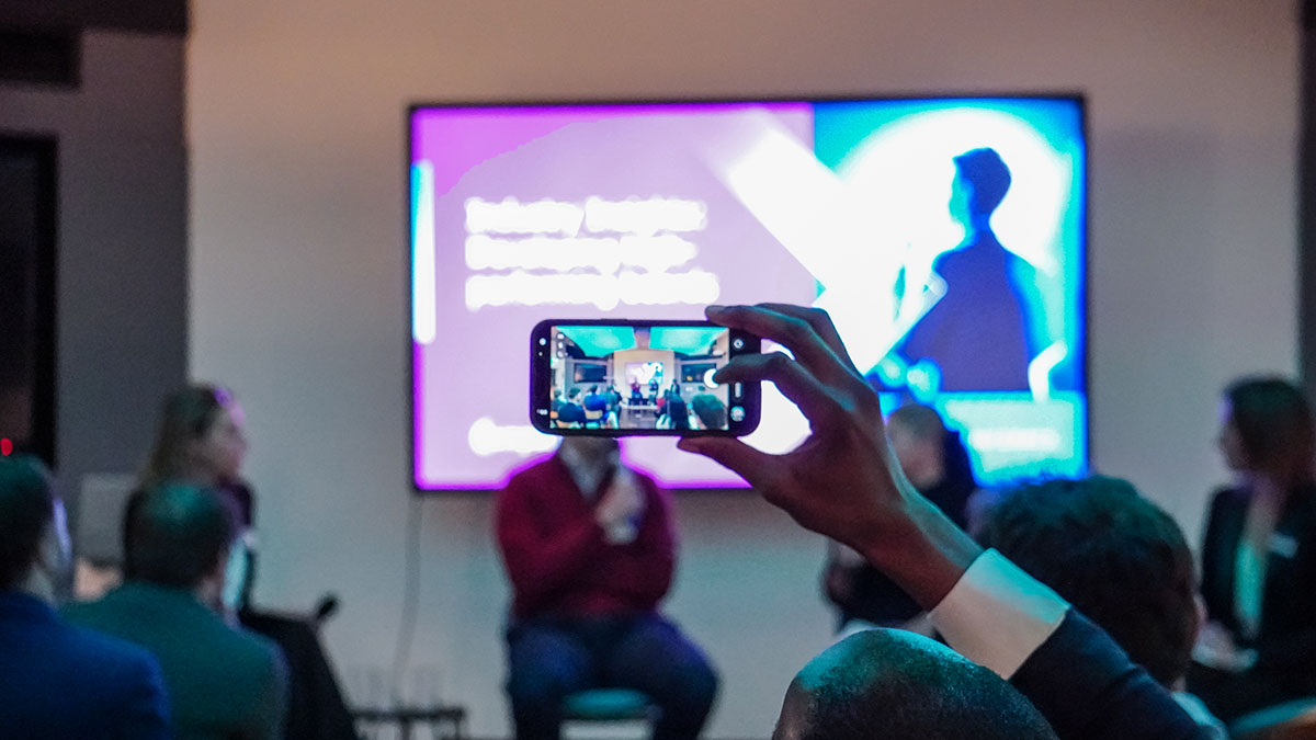 Someone takes a photo of the Industry Insights stage Image of Someone takes a photo of the Industry Insights stage