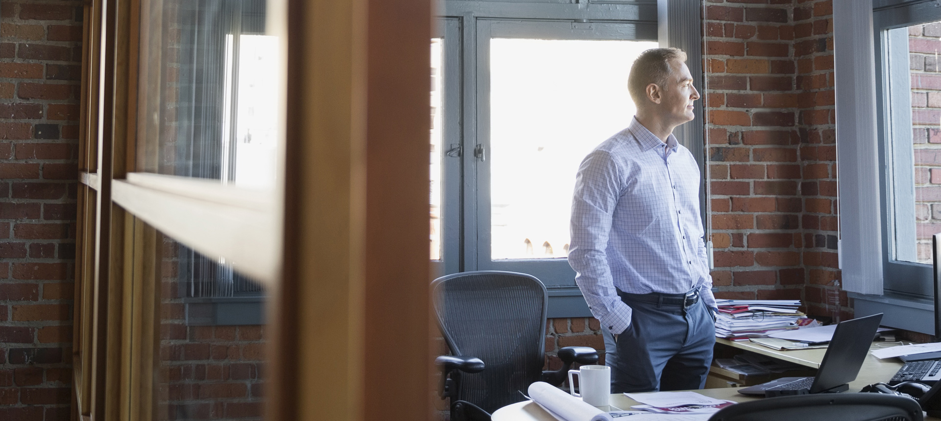 Business Man Looking Out Office Window