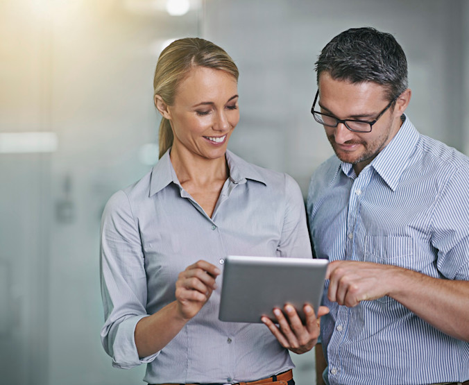 business people looking at tablet