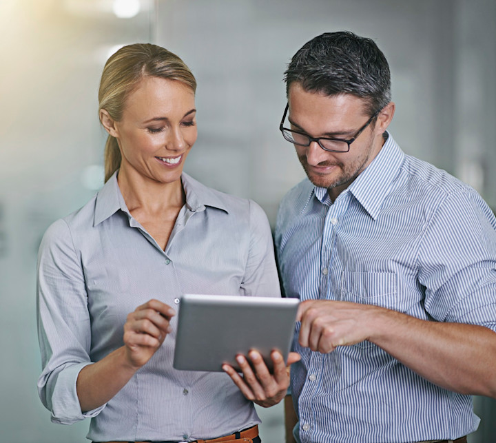 business people looking at tablet