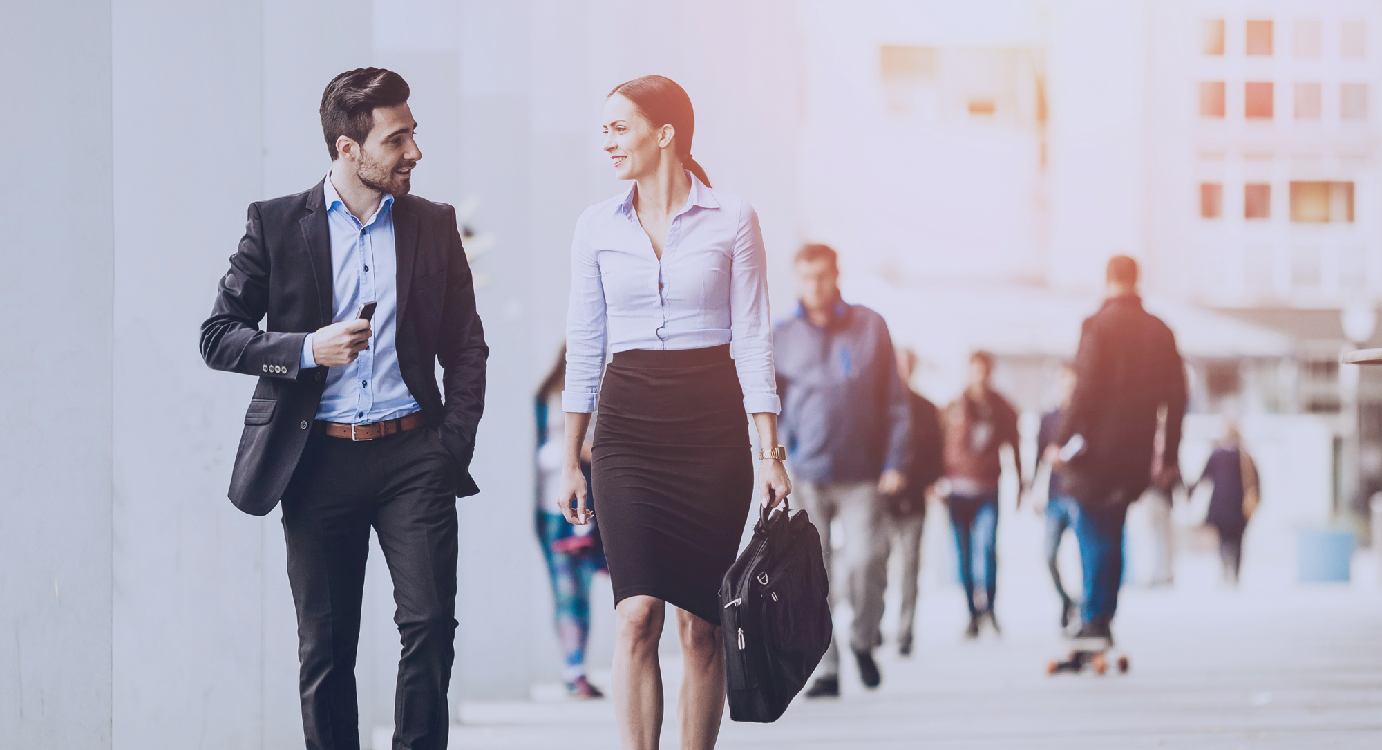 Two professionals walk and have a conversation.