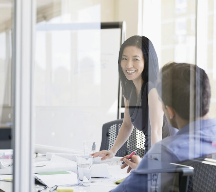 business-people-reviewing-paperwork-at-desk-in-office