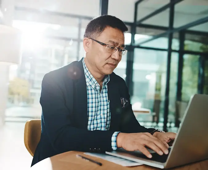 asian businessman on laptop