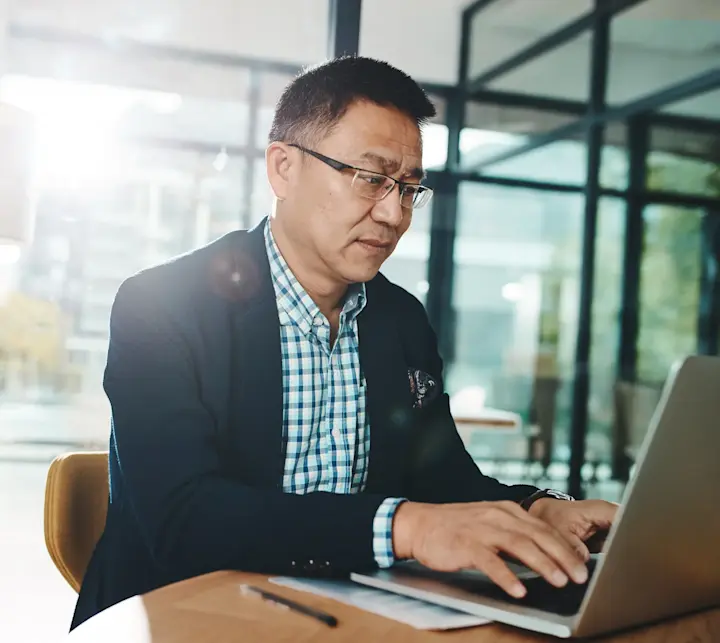 asian businessman on laptop