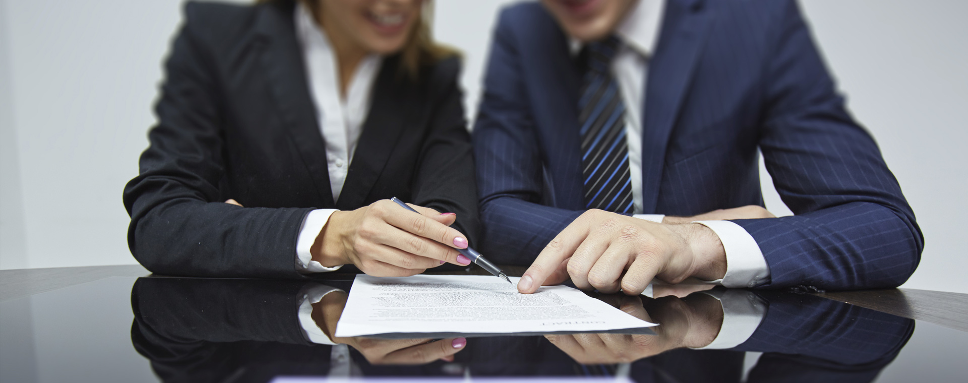Two people looking at a report
