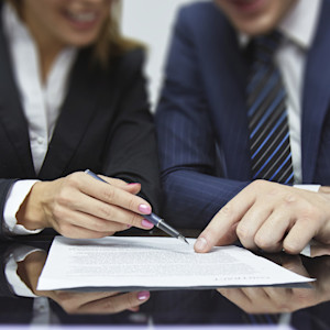 two business people looking at a report