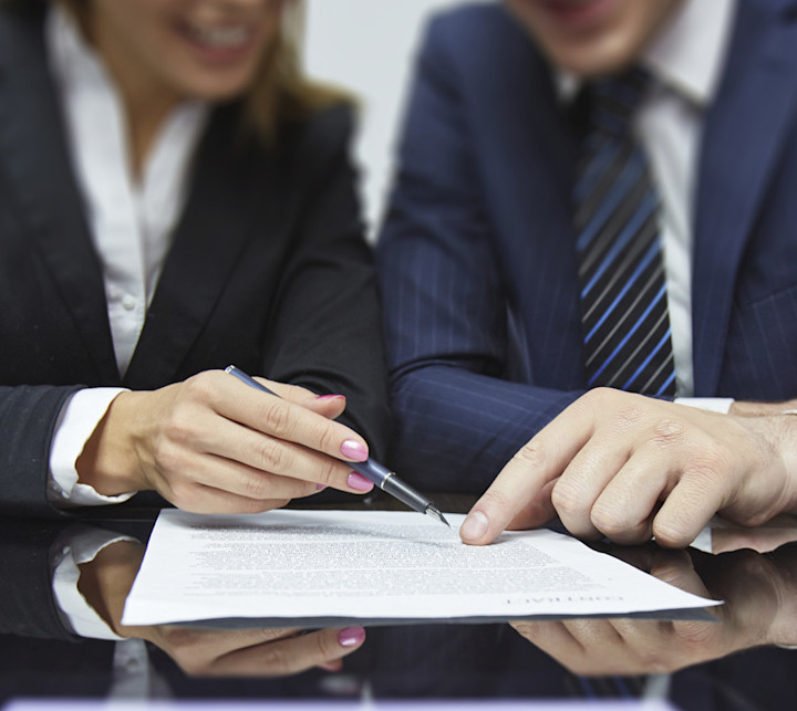two business people looking at a report