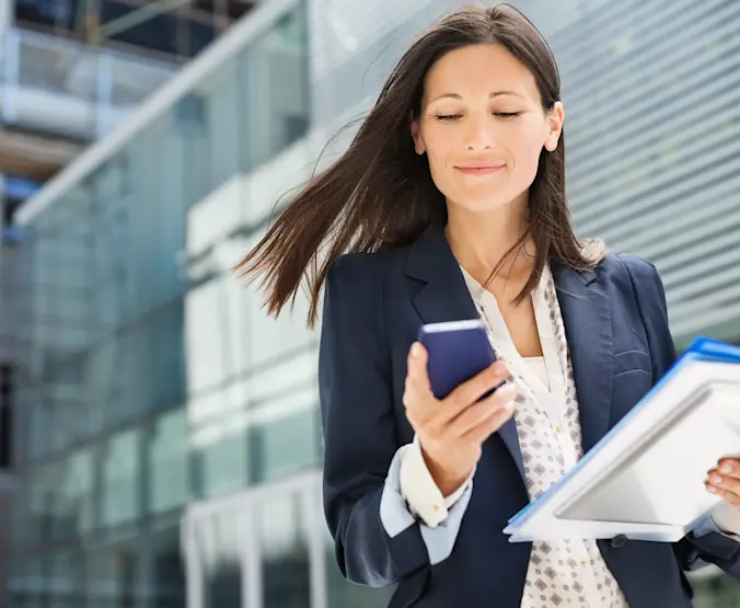 Businesswoman using cell phone in office