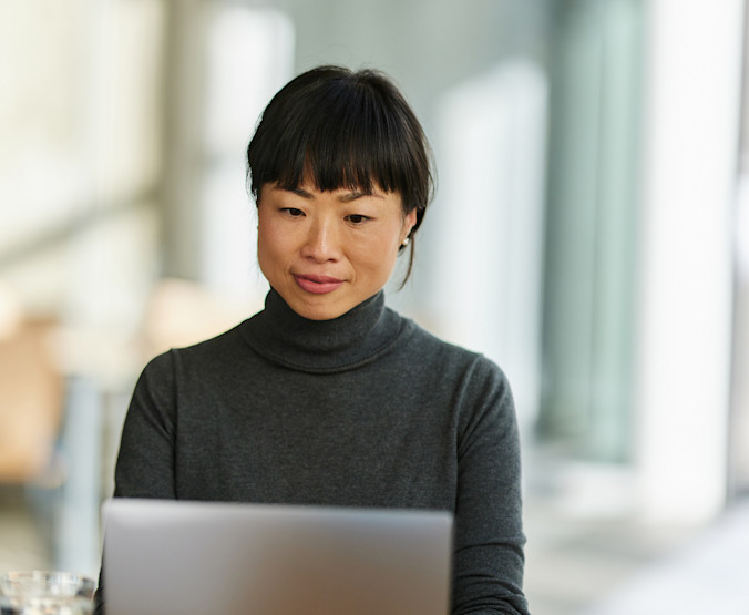 GettyImages-1824281827-woman-using-applications-on-laptop
